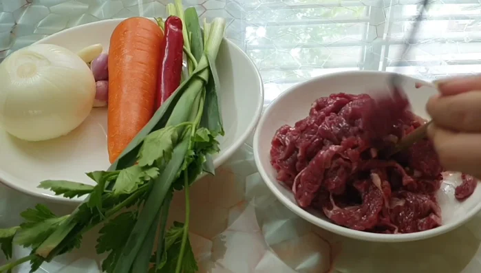 Add vegetables and continue stir-frying. (No specific instructions in transcript)
