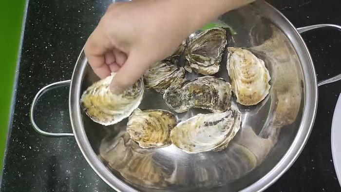 Wash and briefly steam the oysters. This makes them easier to open and cook (14.24). A little beer added to the steaming liquid adds fragrance and reduces the fishy smell (40.64).