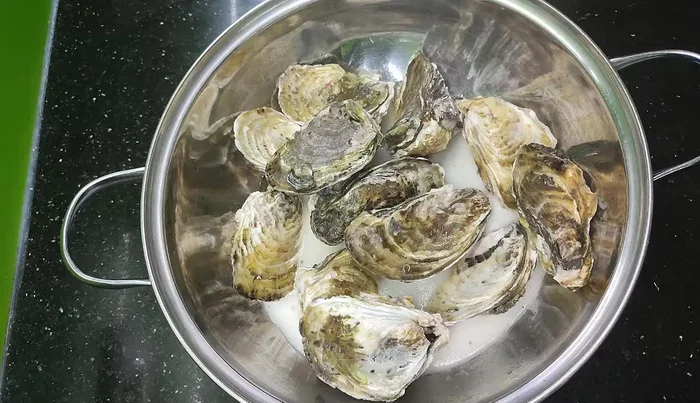 Prepare oysters for your chosen method: Grill on a shell with scallions, bake with cheese in the oven, or steam until cooked (29.08, 33.44).