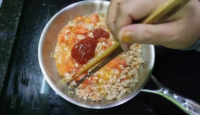 Simmer until the tomatoes are soft and the sauce has thickened.