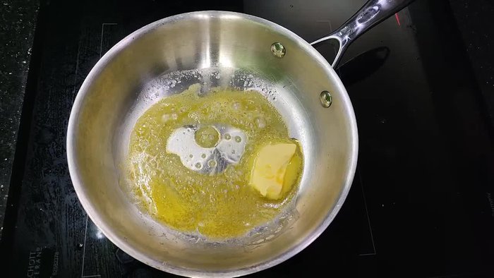 Add butter to a pan. Then add minced garlic and onions, sautéing them together.