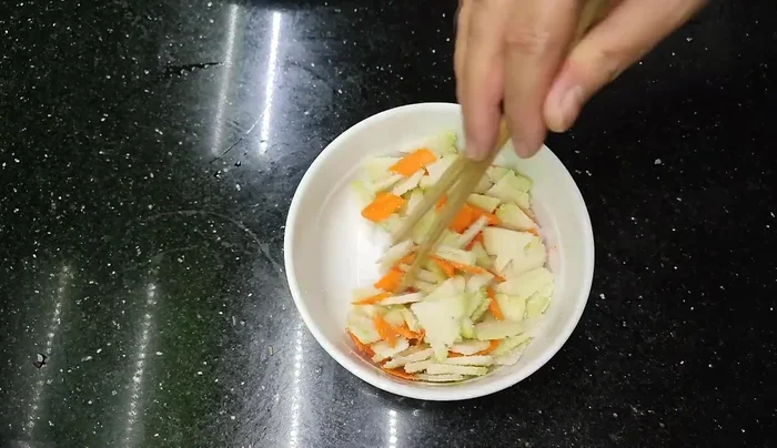 Marinate the sliced vegetables with a little salt and sugar for 15-20 minutes to reduce bitterness and create a crunchy texture. This will also draw out excess water.