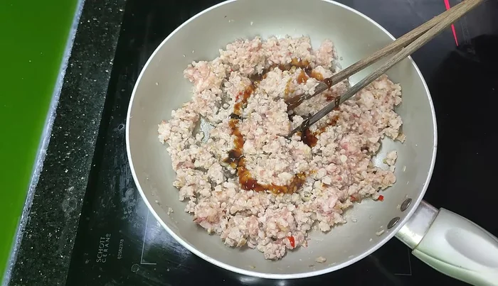 Add oyster sauce, salt, fish sauce, MSG, soy sauce, and chili to taste.