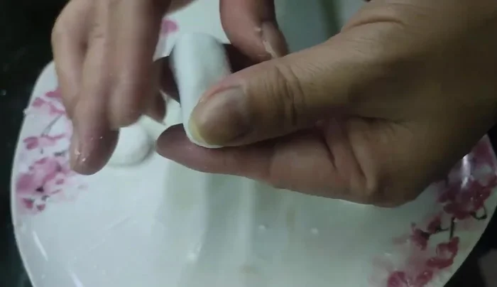 Knead the dough into small, flattened cake shapes.
