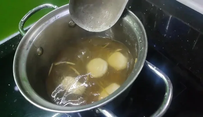 Gently drop the unfilled, flattened rice cakes into the boiling water. Cook until they float to the surface.