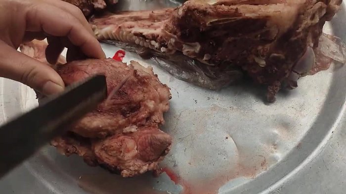 Cut the whole side of pig cheek into four pieces. Then cut them into smaller, manageable pieces.