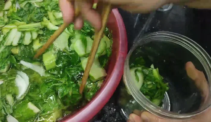 Transfer the cabbage to new jars. Change the brine with fresh, salty water.
