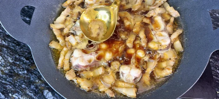 Continue braising for another period, until the fish is cooked through.