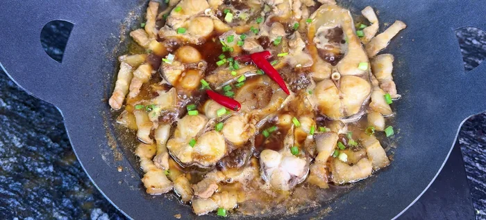 Add green onions, chili peppers, and onion roots for garnish.