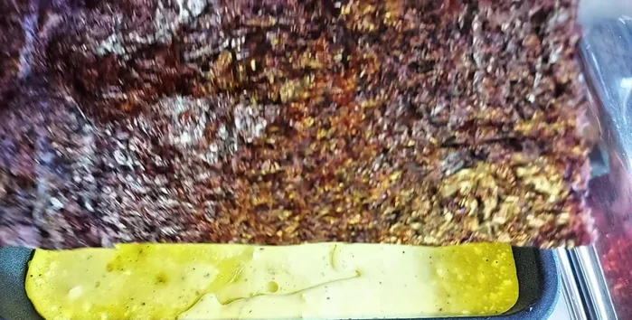 Once cooked, place a seaweed sheet on top of the egg layer.