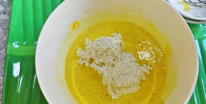 Add the ground tofu to the flour mixture and beat gently until evenly combined and thick. Add more flour if needed to achieve desired consistency.