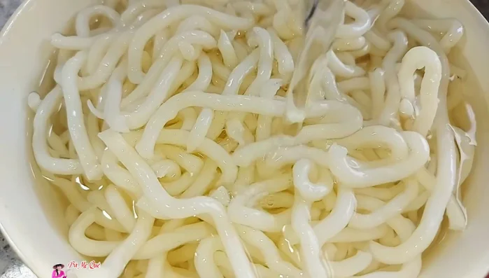 Blanch the rice noodles in boiling water for 3 minutes, then drain.