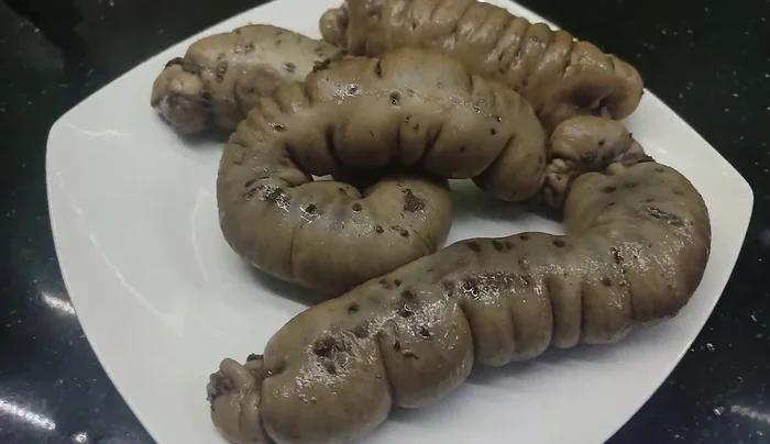 Remove the cooked sausages, let them cool slightly, and slice them before serving.