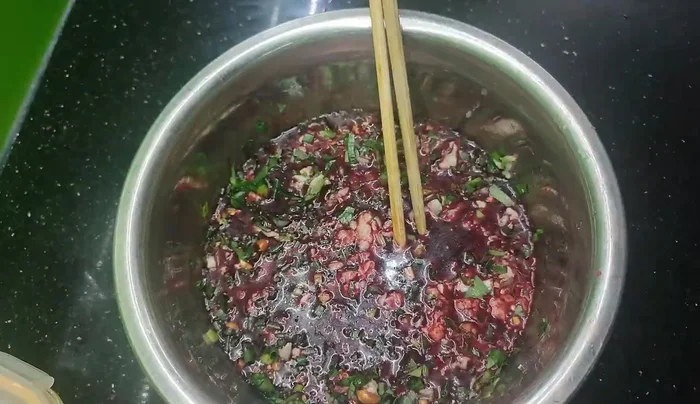 Carefully stuff the mixture into the prepared intestines. Tie off both ends.