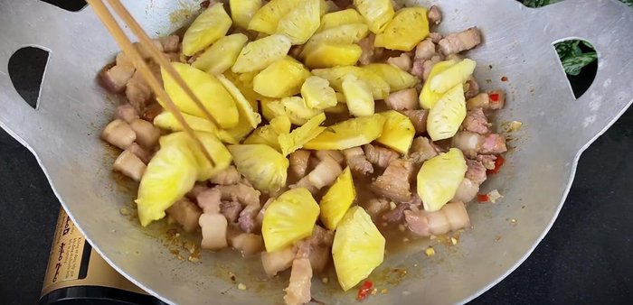 Add pineapple and sugar: After the meat is cooked, add the marinated pineapple and sugar. Reduce heat to low and simmer slowly, stirring occasionally, until the sauce thickens.