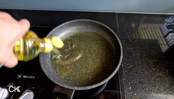 Heat oil in a pan. Fry the tofu until golden brown on both sides, ensuring medium heat to avoid dryness. When golden, increase heat for 10-15 seconds to crisp the outside.