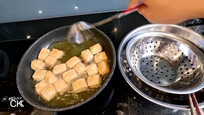 Remove tofu from pan and place in a basket to drain excess oil.