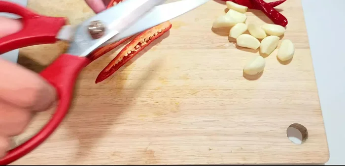 Prepare the chili peppers: Cut in half, remove seeds, and mince finely. (100.52)