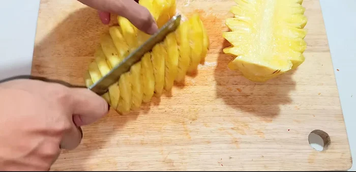 Prepare the pineapple: Cut in half, remove the hard core, and blend with 1/2 cup of water until smooth. (143.519)