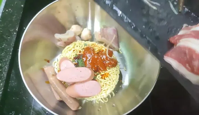 Add your choice of toppings (sausage, fried fish balls, squid, American beef, mushrooms, vegetables, sweet corn, cabbage, enoki mushrooms, mustard greens).