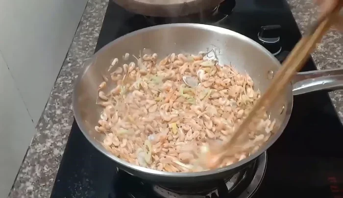 Roast shrimp until dry and curled. Add water and continue to roast until hardened.