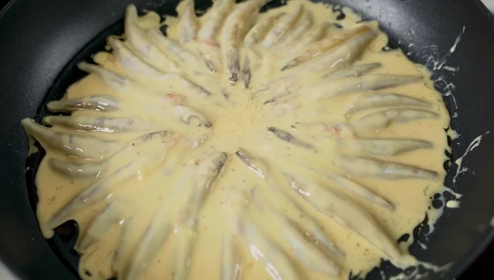 Pour the remaining batter into the pan, filling gaps to form a seamless cake.