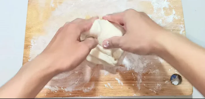 Knead the risen dough and roll it out into a circle to fit your pan.