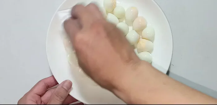 Pat the peeled eggs dry with a paper towel.