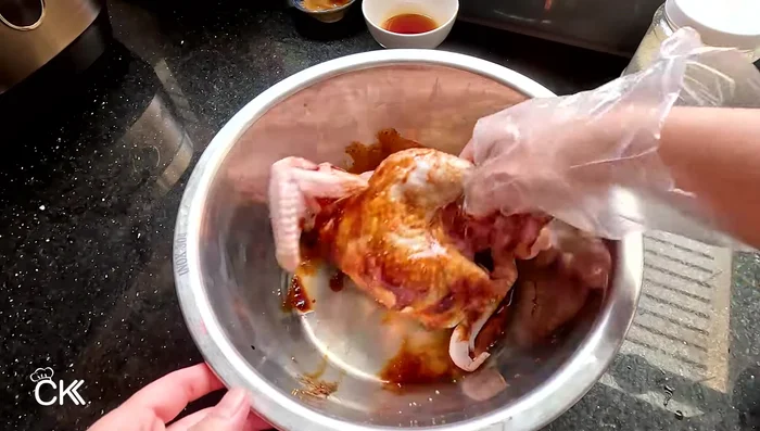 Marinate the chicken with the mixture, ensuring it's evenly coated inside and out. Wrap in plastic wrap and refrigerate for 30 minutes to 1 hour.