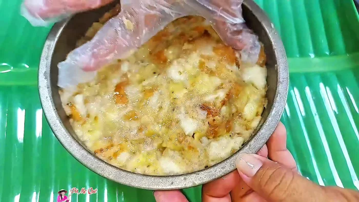 Press the banana bread mixture firmly into the prepared cake pan.