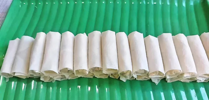 Heat cooking oil in a pan. Fry the spring rolls over low heat until golden brown, increasing heat slightly towards the end for a crispier finish.