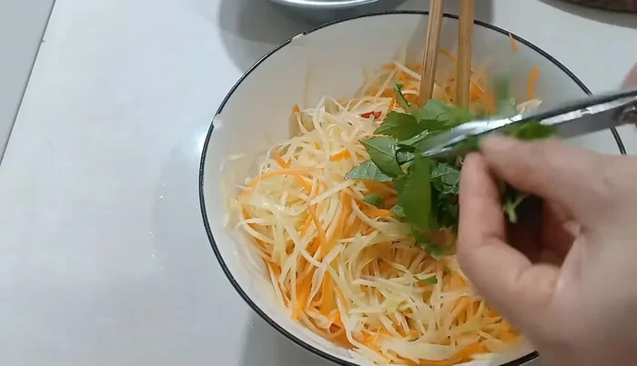 Add chopped basil and rau răm (if using).