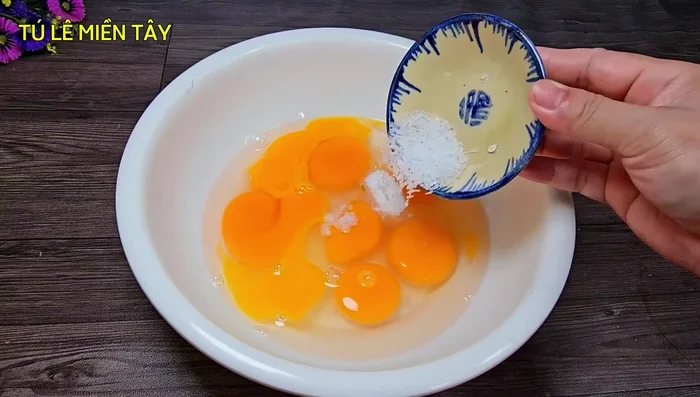 In a bowl, whisk together the eggs, salt, sugar, MSG, fish sauce, pepper, and chopped green onions.