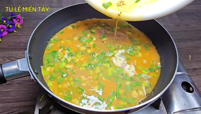 Pour the egg mixture into the pan. Cook over low heat.