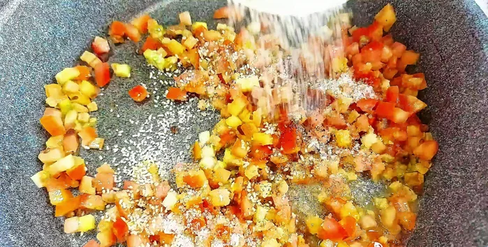 Add sugar, vegetarian seasoning, ground pepper, and water. Cook until tomatoes are soft.