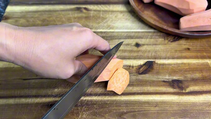 Prepare sweet potatoes: Wash and slice the sweet potatoes thinly.