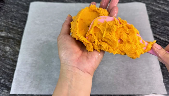Assemble the cakes: Take a portion of the sweet potato filling and place it in the center of a piece of rolled-out crust. Wrap the filling completely with the crust.