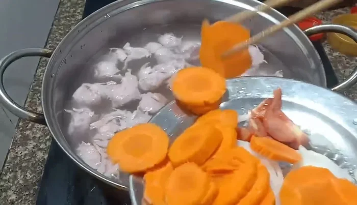 Add carrots to the pot to sweeten the soup.
