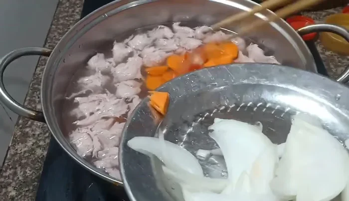 Add onions and tomatoes to the pot.