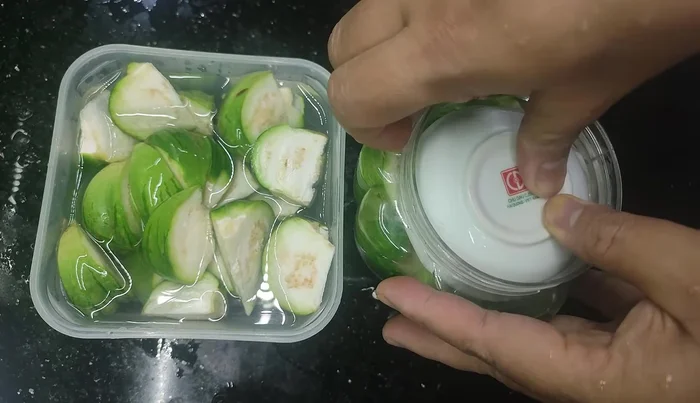 Press down firmly to ensure the eggplant is fully submerged in the brine.