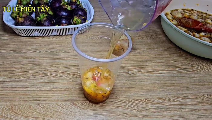 Assemble the drink: In a 700ml glass, combine 80ml of mangosteen mixture, 30ml (or 40ml for sweeter taste) of sugar syrup, 50ml of cooled brewed tea, and ice.
