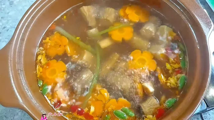Finish the soup: Add vegetarian fish sauce and a generous amount of basil. Stir well. Turn off the heat.