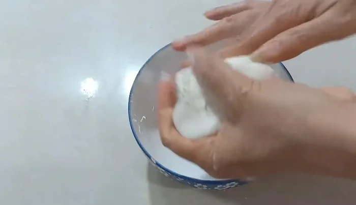 Roll the dough into a log and cut it into small pieces. Shape the pieces into small balls.