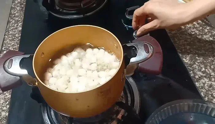 Remove the cooked pearls and immediately rinse them with cold water to stop the cooking process.