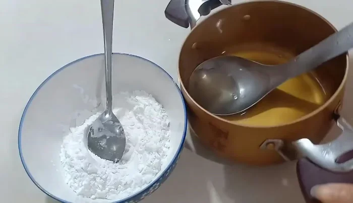 Remove the sugar water from the heat. Immediately add the lentil flour to the hot sugar water.