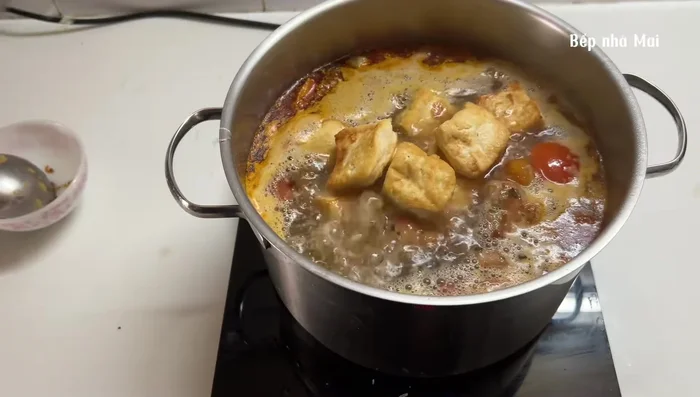 Fry crab patties until cooked and add to the broth. Add fried tofu, fried onions, and season to taste.