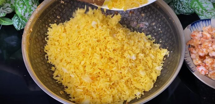 Add marinated rice and stir-fry until fluffy.
