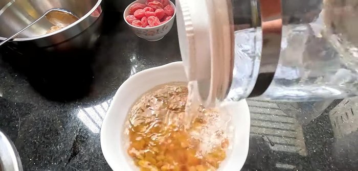 Boil the raisins in water until they expand. No need to wash if they are already clean.