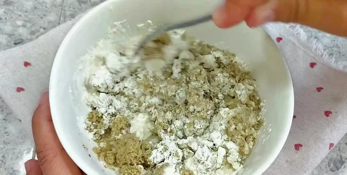 Gradually add water, mixing until a thick, elastic dough forms.