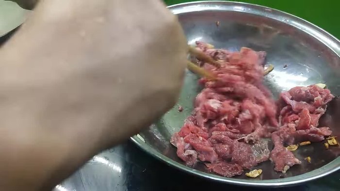 Stir-fry the marinated buffalo meat until it's about 80% cooked.